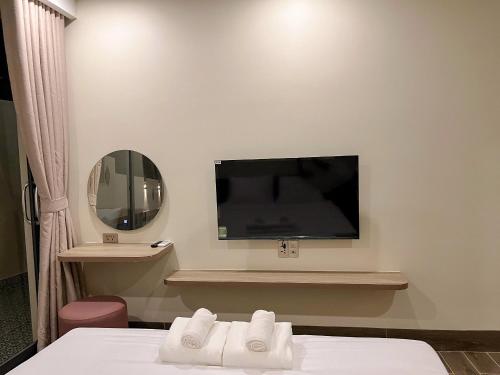 a hotel room with a flat screen tv on the wall at Cham Charm Home Mui Ne in Mui Ne