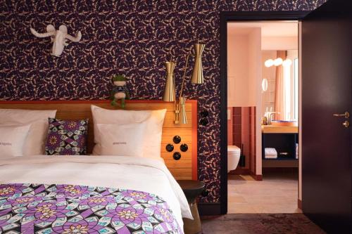 a bedroom with a bed and a bathroom at 25hours Hotel Terminus Nord in Paris