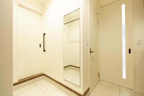 a walk in shower with a glass door at Z LAND Enoshima in Fujisawa
