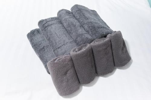 a group of four gray rubber gloves on a white surface at Z LAND Enoshima in Fujisawa