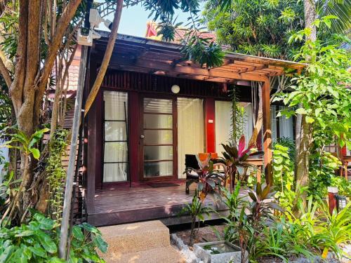 a small house with a wooden porch at Samui Paradise Chaweng Beach Resort in Chaweng