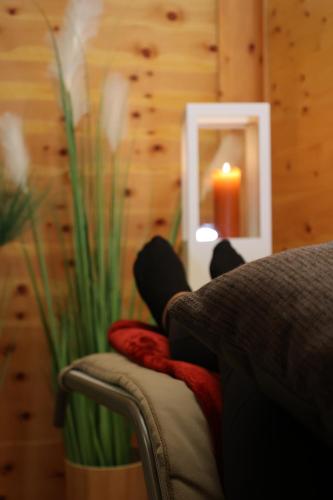 a couch with a candle in a room at CAREA Residenz Hotel Harzhöhe in Hahnenklee-Bockswiese