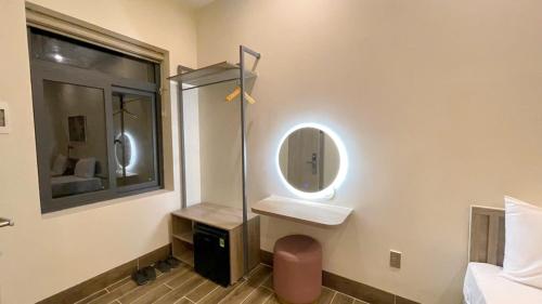 a bathroom with a sink and a mirror at Cham Charm Home Mui Ne in Mui Ne