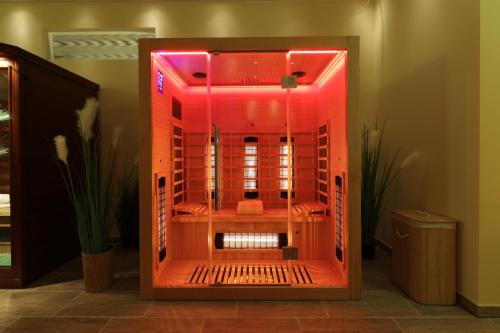 a shower with red lights in a room at CAREA Residenz Hotel Harzhöhe in Hahnenklee-Bockswiese