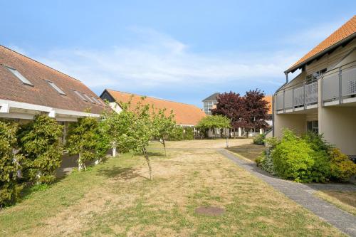 an empty courtyard of a school with trees and buildings at Karrebaeksminde Strandhotel in Karrebæksminde