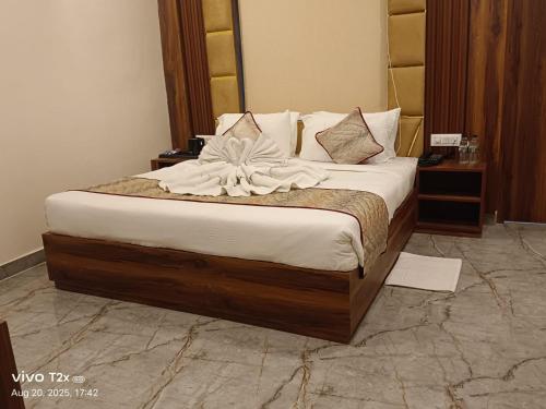 a bed in a hotel room with a flower on it at Chocolate Inn, Patna in Patna