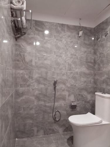 a bathroom with a shower and a toilet in it at Chocolate Inn, Patna in Patna