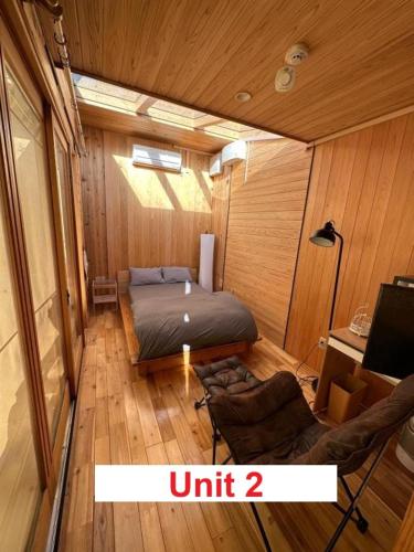 a small room with a bed and a chair in it at Fuji Dome Glamping in Fujikawaguchiko