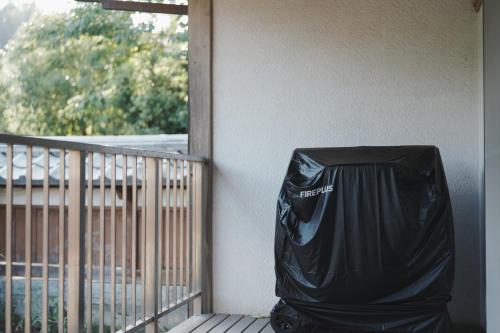 a black trash can sitting on the side of a porch at Enishienoyado Ichihara - Vacation STAY 16539v in Ichihara