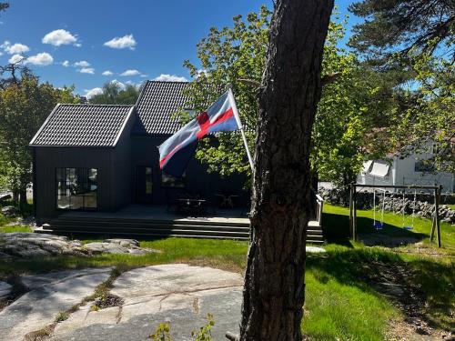a flag flying in front of a house at Large villa Tjärnö Strömstad in Strömstad