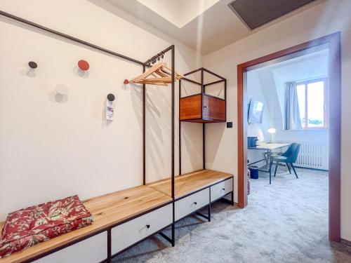 a dressing room with a bed and a desk at Hotel Slovan in Jeseník