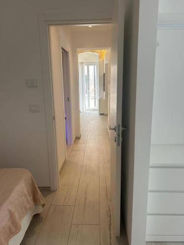 a room with a hallway with a wooden floor at IL GELSO BIANCO Luxury apartments in Polignano a Mare
