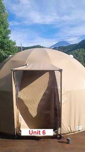 a tent with the door open on top of it at Fuji Dome Glamping in Fujikawaguchiko