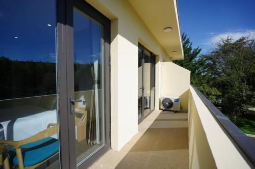 a balcony of a house with glass doors at Beidaihe Yijing Hotel in Qinhuangdao
