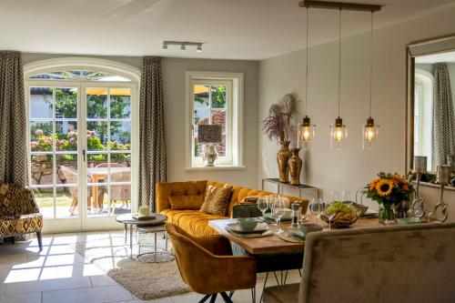 a living room with a couch and a table at Haus Sylter Schönheit in Hörnum