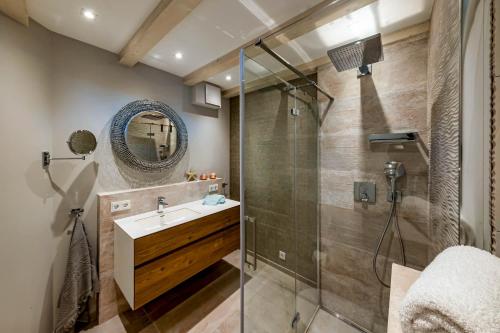 a bathroom with a shower and a sink and a mirror at Haus Sylter Schönheit in Hörnum