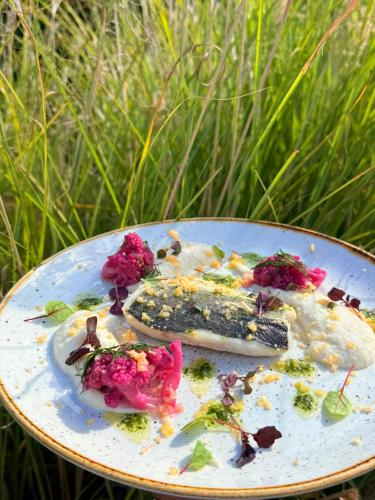 a plate of food with flowers on it at B&B HOTEL Cergy Port 4 étoiles in Cergy