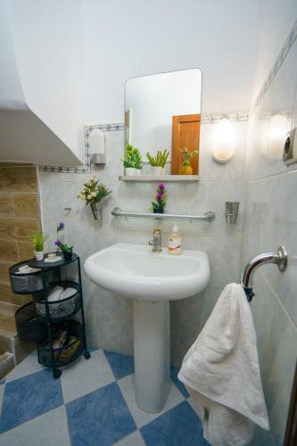 a bathroom with a sink and a mirror at Garden apartment in Ksar es Sghir