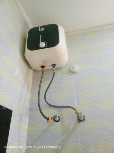 a hair dryer on the wall of a room at Exvan Apartments in Ketti