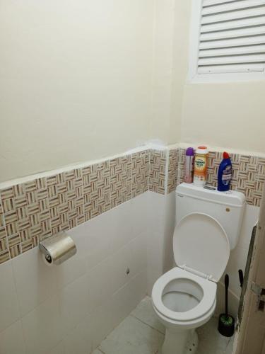 a bathroom with a white toilet in a room at Lisas bnb in Ongata Rongai 