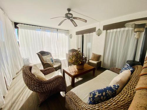 a living room with a bed and wicker chairs at La Senda de Olmeda in Olmeda de las Fuentes