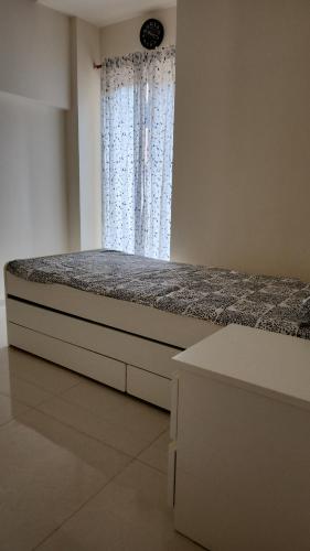 a bed in a room with a window and a mattressitures at CASA HILLSIDE Dapoli 2BHK AC Apartment in Dapoli