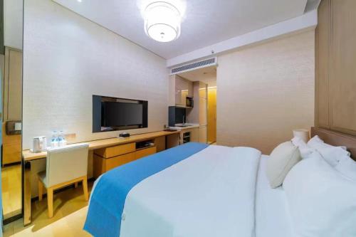 Ein Bett oder Betten in einem Zimmer der Unterkunft Yizhimei Light Residence