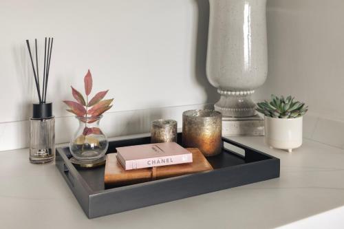 a black shelf with candles and a box on it at The Retreat in Penruddock