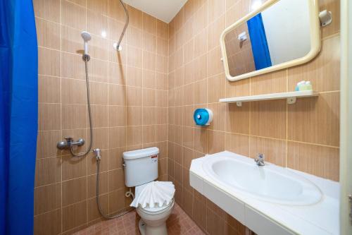 a bathroom with a shower and a toilet and a sink at Oceanview Bungalows by EAT in Karon Beach
