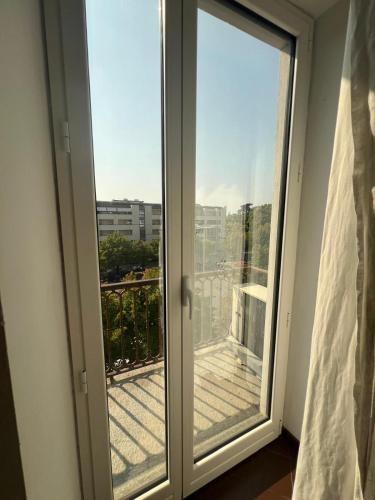 a sliding glass door with a view of a balcony at Appartamento Carlo Alberto in Bra