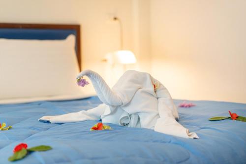 a swan made out of towels on a bed at Oceanview Bungalows by EAT in Karon Beach