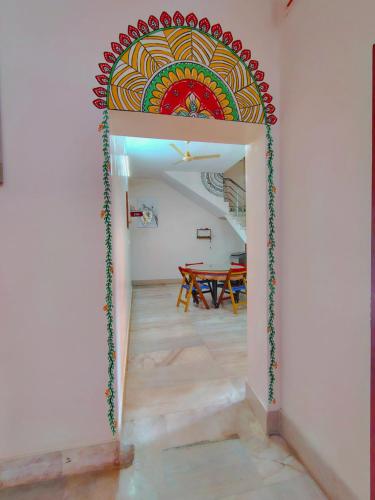 a room with a painting on the wall at Aidan Inn in Udupi