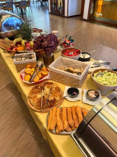 a table topped with lots of different types of food at Hotel Happy in Dimitrovgrad