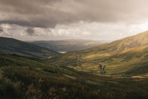 a view of a valley with a road in the mountains at The Sanctuary - Ridgestone in Watermillock
