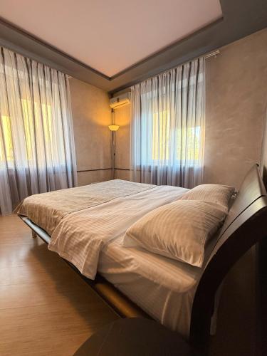 a large bed in a bedroom with a window at Kyiv Paris Apartment in Kyiv