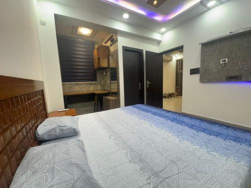 a bedroom with a large bed in a room at Pablo Place in Ghaziabad