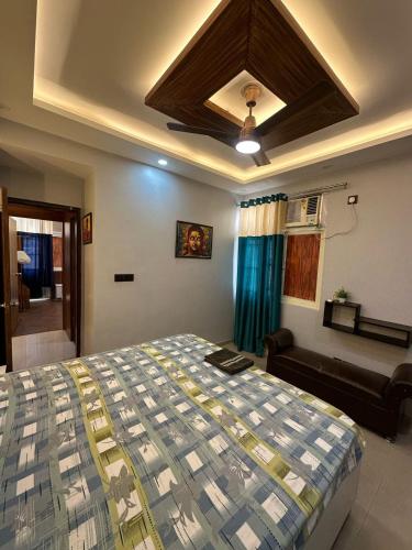 a bedroom with a bed and a couch at Pablo Place in Ghaziabad