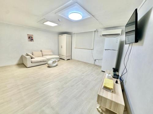 a living room with a couch and a tv at 경주펜션 Gyeongju Pension in Incheon