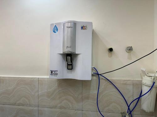 a water heater on a wall next to a toilet at Pablo Place in Ghaziabad