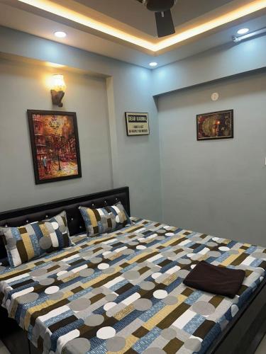 a bedroom with a bed with a quilt on it at Pablo Place in Ghaziabad