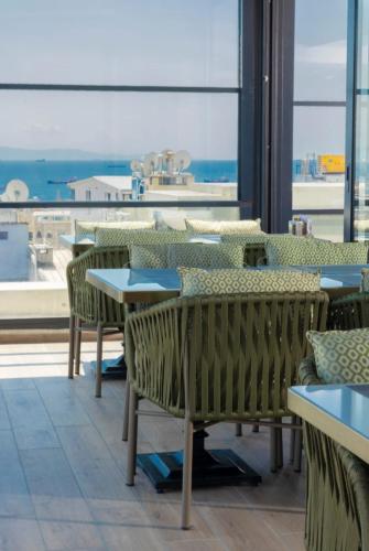 un ristorante con tavoli e sedie e una grande finestra di Lions Royal Hotel a Istanbul