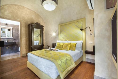 a bedroom with a large bed and a bathroom at èROMA - PANTHEON LUXURY SUITE in Rome