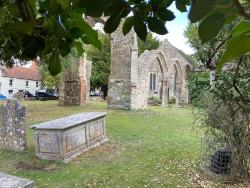 an old stone church with a bench in the yard at The Deli, Wilton in Wilton