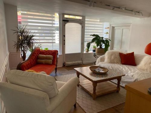 a living room with a couch and a table at The Deli, Wilton in Wilton