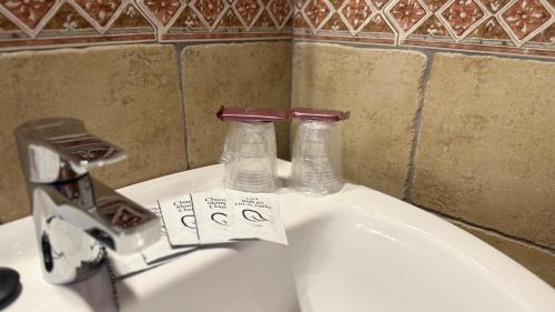 a bathroom sink with two bottles on top of it at HOTEL LOS GUILOS in Gorafe