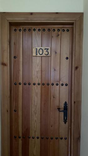 a wooden door with the number on it at HOTEL LOS GUILOS in Gorafe