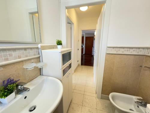 a bathroom with a sink and a mirror at 5' from Lake Iseo, Your Oasis of Peace in Paratico