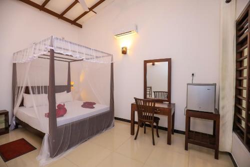Ένα ή περισσότερα κρεβάτια σε δωμάτιο στο Tinara River Inn, Weligama