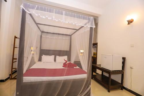 Ένα ή περισσότερα κρεβάτια σε δωμάτιο στο Tinara River Inn, Weligama