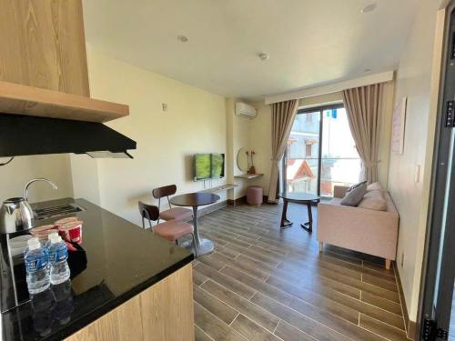 a kitchen and living room with a counter and a living room at Cham Charm Home Mui Ne in Mui Ne